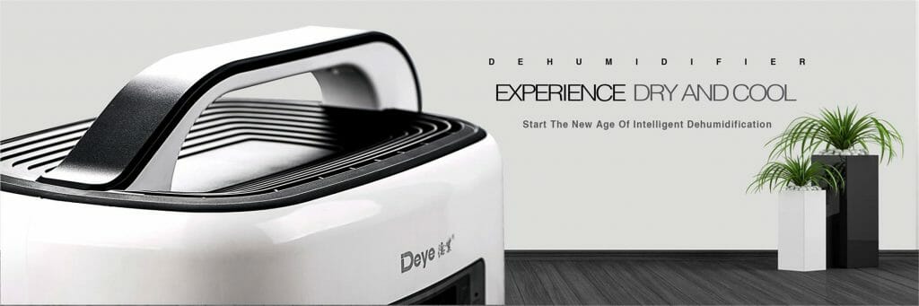 Close-up of a white dehumidifier and potted plant on a wooden floor. Wall text: "Experience Dry and Cool" and "Enter The New Age Of Intelligent Dehumidification.