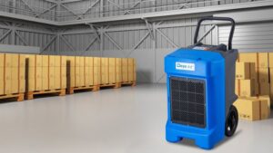 Heavy-duty blue industrial dehumidifier in a warehouse setting, designed for controlling humidity levels and preventing moisture damage in large storage areas.